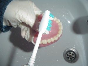 Brushing denture, please pool the sink with water or brush the denture on top of a thick towel to prevent unnecessary breakage when denture accidentally falls. Picture taken from dentsectortv.wordpress.com/.../
