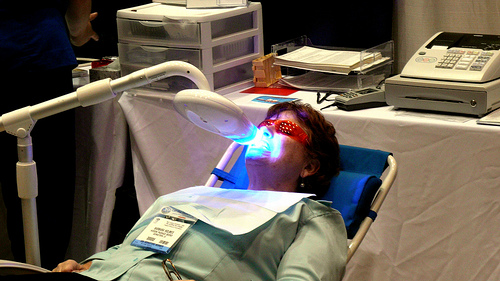 Patient recieving laser teeth whitening treatment, picture courtesy of gruntzooki, Flikr